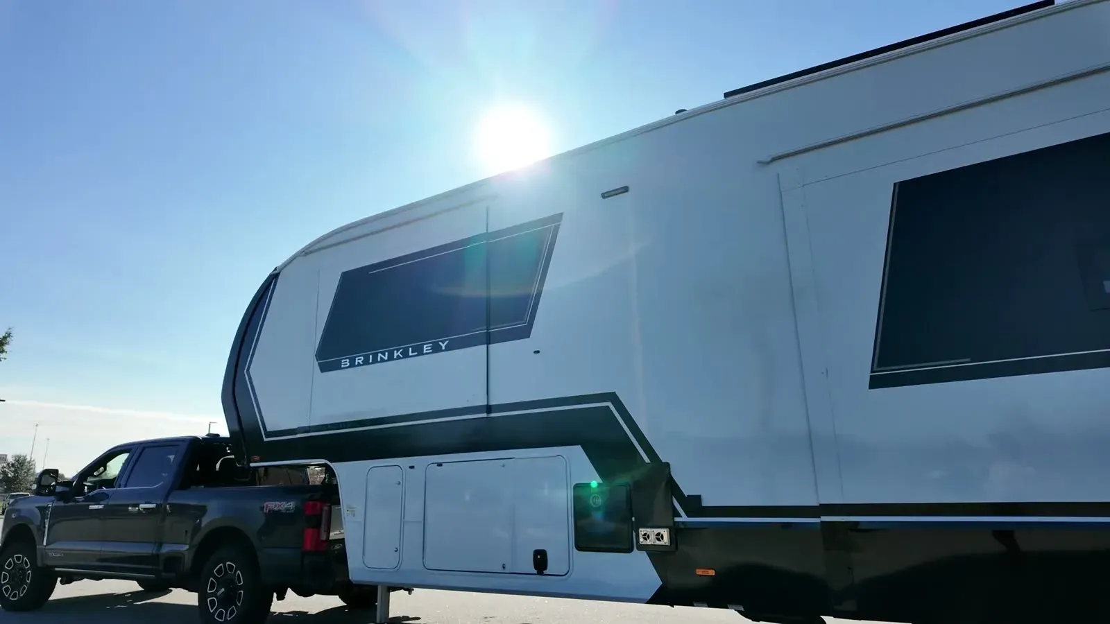 Our F-350 hitched to the Brinkley Model Z, rolling through the practice parking lot under the Florida sun.