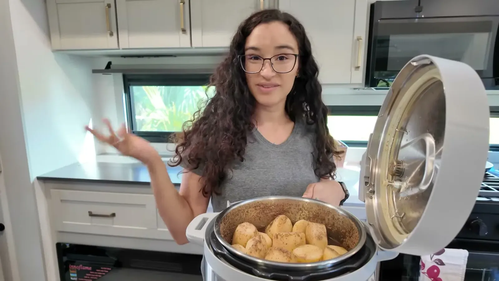 The open Instant Pot with chopped potatoes settled down among the pieces of stewed beef, ready for the last five minutes