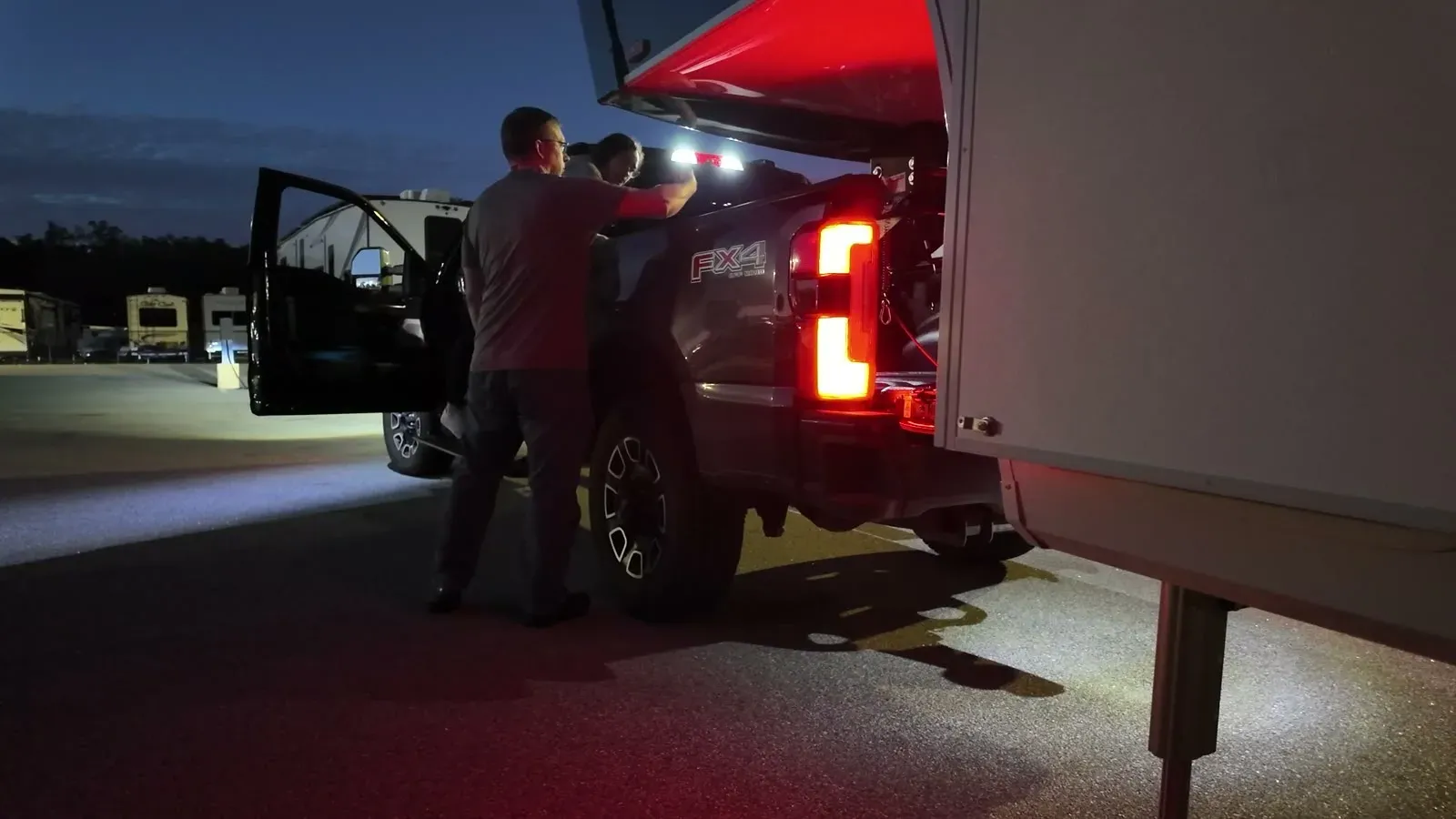 Lining up the kingpin over the truck bed by flashlight and tail-light glow during our first solo hitch attempt after dark.